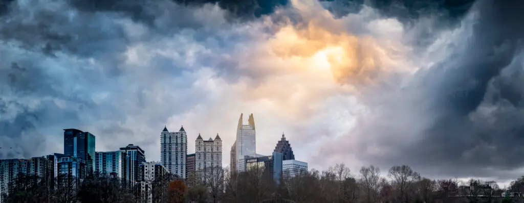 Thunderstorm approaching Atlanta skyline during storm season - protect your commercial roof