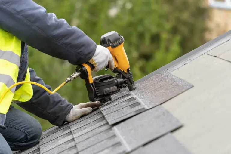 Roofer repairing a flat roof - flat roof repair vs replacement decision guide
